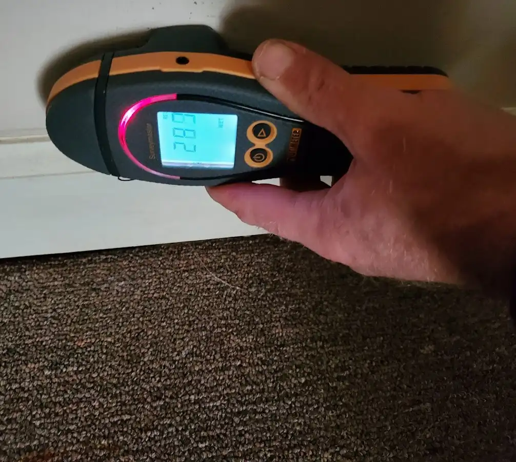 Moisture detection at baseboard during Storm Damage Restoration in Four Corners